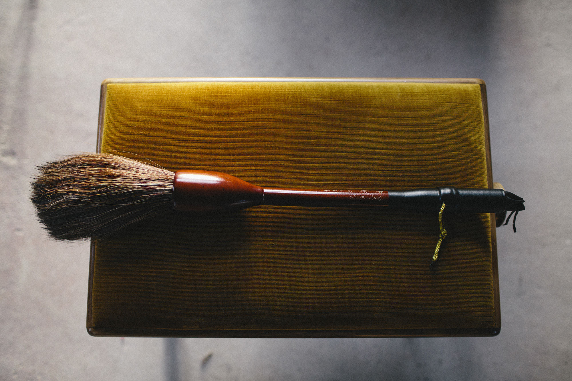 Aoi's calligraphy brush with Mika's motion sensor _ photo by Corey Fuller